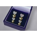 A pair of 14ct white and yellow gold, diamond set heart shaped drop earrings