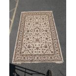 An ivory ground Kashmir carpet with an all over floral pattern, 78" x 120"