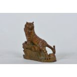 An Oriental coppered metal tiger, 4 character marks to side, 2½" high