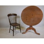A tilt top pine table, raised on a turned column and tripod supports and C19th Oxford chair with elm