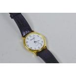 A classic Ingersoll Quartz wristwatch, gold plated bezel, serial number IN33009G, black leather
