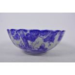 A Chinese blue and white porcelain bowl of ribbed design decorated with many figures, A/F chip to