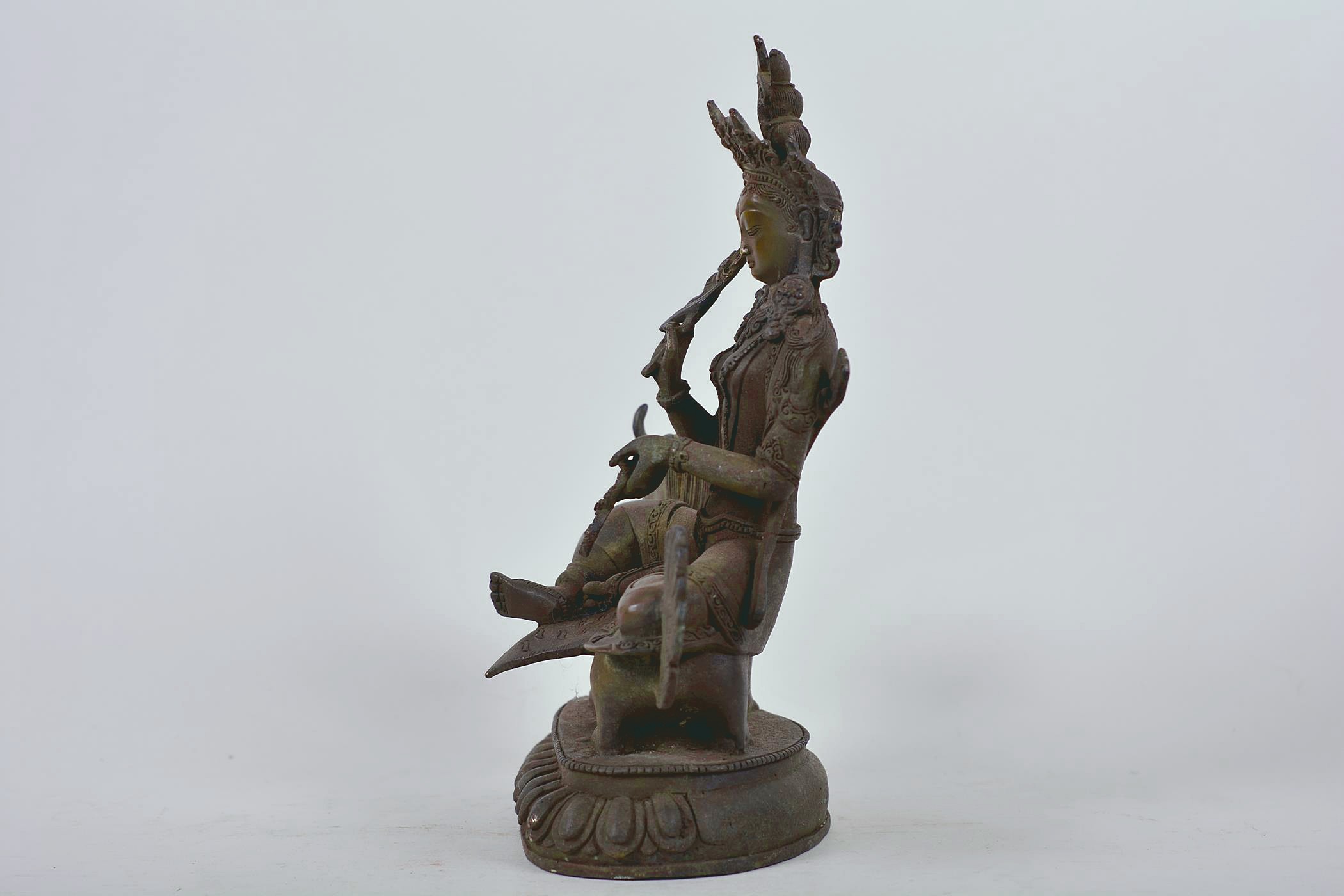 A Chinese patinated bronze figure of Buddha seated on a mythical beast, 10" high - Image 4 of 6