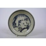 A Chinese blue and white pottery dish decorated with figures in a garden, 6 character mark to