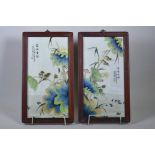 A pair of Chinese polychrome porcelain panels decorated with birds and lotus flowers, mounted in