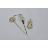 A Chinese jade mounted white metal hairpin with Buddha decoration, together with a white metal