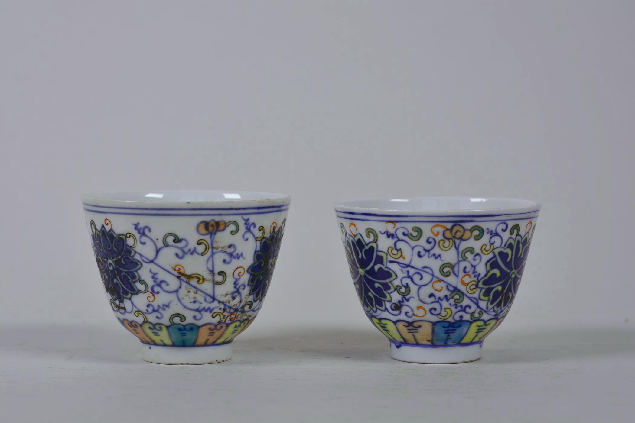 A pair of Chinese doucai porcelain tea bowls with lotus flower decoration, 6 character mark to base, - Image 2 of 4