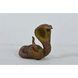 An Oriental coppered metal cobra, indistinct marks to base, 2" high