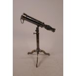 A brass reproduction telescope on tripod stand, 9½" long collapsed