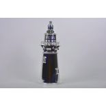 A silver plated novelty cocktail shaker in the form of a lighthouse, 13½" high