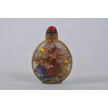 A Chinese glass snuff bottle with polychrome decoration of birds and flowers, 4 character mark to