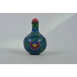 A Chinese cloisonné snuff bottle with lotus flower and auspicious symbol decoration, 3" high