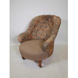 A Victorian tub shaped button back easy chair, raised on turned supports