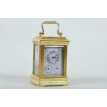 A brass cased miniature carriage clock with Sevres style porcelain panels and two subsidiary date