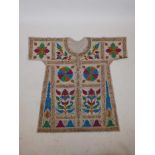 An Islamic linen tunic, decorated with polychrome patterns and all over calligraphy, 42" long
