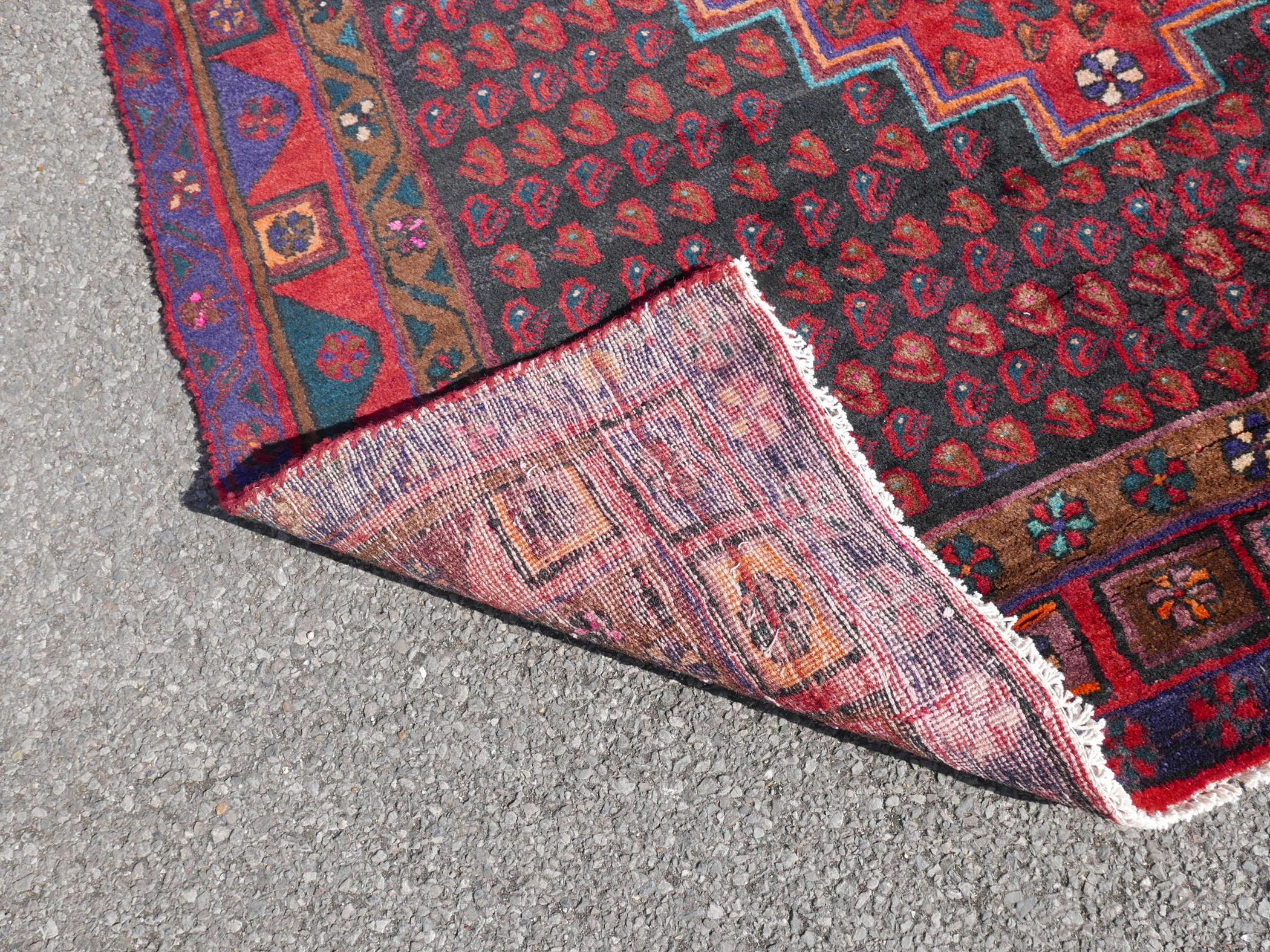 A Persian red ground Hamadan luri rug, 61" x 18" - Image 4 of 4