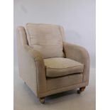 A cream DFS armchair