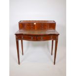 A Regency style mahogany serpentine fronted bonheur du jour, with leather inset top, six drawers