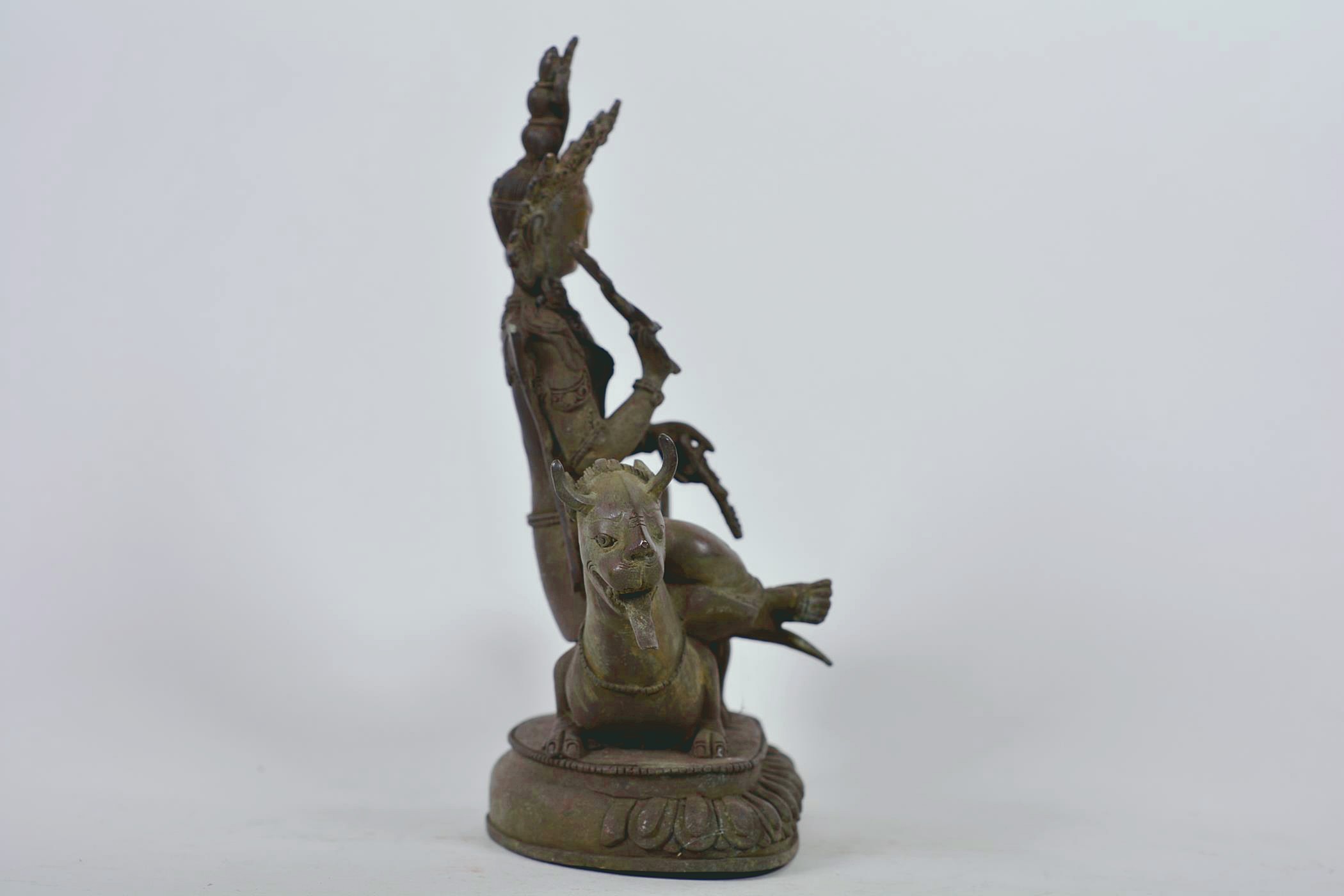 A Chinese patinated bronze figure of Buddha seated on a mythical beast, 10" high - Image 3 of 6