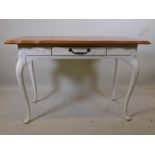 A French style oak single drawer side/writing table, with shaped top, raised on cabriole supports,