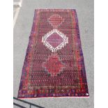 A Persian red ground Hamadan luri rug, 61" x 18"