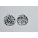 A pair of Islamic silvered metal pendants with calligraphy decoration, 1" diameter