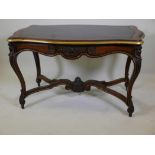 A C19th French rosewood and brass mounted centre table, the serpentine top with gilt tooled inset