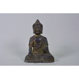 A Chinese bronze of Buddha with a gilt patina, 7" high