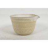 A studio pottery ribbed bowl with pouring spout, impressed mark 'M', 4" high, 5½" diameter