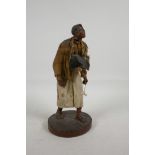 A wax figurine of an American turkey vendor, on a wood base, 11" high