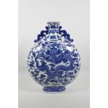 A large Chinese blue and white porcelain moon flask with two handles, decorated with a dragon