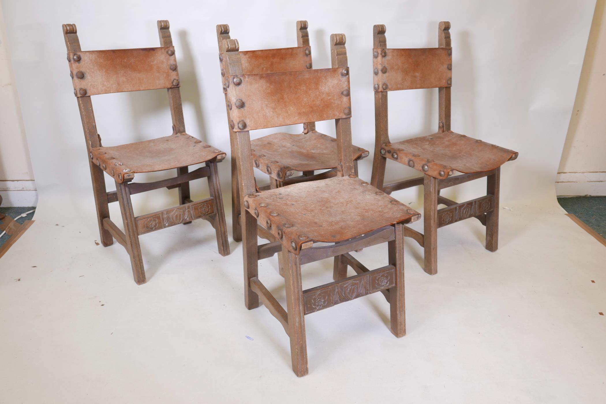 A set of four beechwood monk's chairs, with leather back and seats, iron stud decoration, and carved - Image 2 of 4