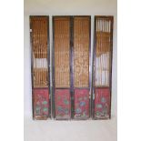 A Chinese four fold screen, with gilt trellis and inset carved and painted pine panels, late