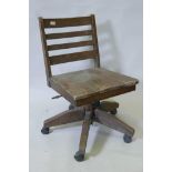 A ladderback hardwood tilt and swivel oak chair