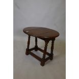 An oak occasional table with swivel top and drop flaps, 20" x 22" x 18"