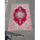 A Persian multicolour ground Tabriz carpet with a traditional floral medallion design, 72" x 109"