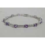 A 925 silver, cubic zirconium and amethyst set bracelet, 7" long