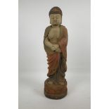 A Chinese carved wood Buddha with cracked polychrome paintwork, 22" high
