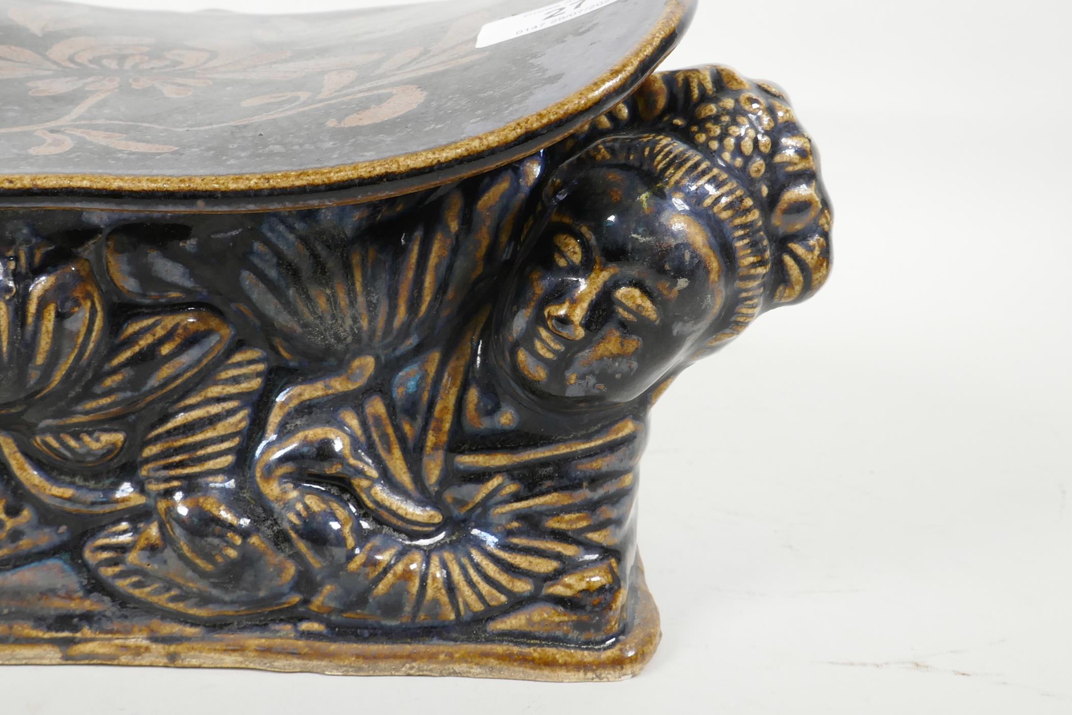 A Chinese Cizhou kiln pottery head rest moulded in the form of a reclining figure, with blue black - Image 2 of 4