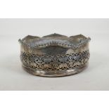A silver plated table centrepiece coaster, with pierced foliate decoration and gadrooned rim, and