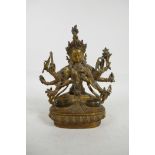 A Sino-Tibetan gilt bronze of a many armed deity, with coral and turquoise settings, 9" high, 6