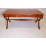 A mahogany coffee table on cross end supports, united by a stretcher, with a single drawer, 25" x
