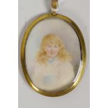 A gilt framed portrait of a young girl, 2¼" x 3"