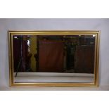 A gilt framed wall mirror with bevelled glass, 56" x 36"