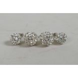 A pair of silver and cubic zirconium encrusted stud earrings and another smaller pair