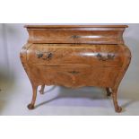 A Continental walnut bombe shaped commode, with single frieze drawer over two, raised on shaped