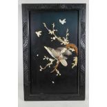 A Japanese lacquer wall plaque with applied decoration of birds and flowering branch, made from