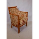 An Ashley Lawrence beechwood show frame armchair, upholstered in a terracotta and gold fabric
