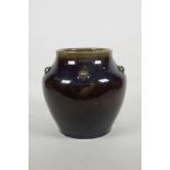 A Chinese porcelain purple flambé glazed vase with embossed decoration to the shoulders, mark to