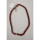 A pressed amber glass bead necklace, 24" long